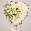 A graceful heart-shaped standing tribute designed with abundant white roses, elegant lilies