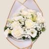 White roses and calla lilies in a wrapped bouquet