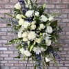 Large white and blue floral standing arrangement on a black easel