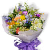 A sweet seasonal cello wrapped bouquet filled with fresh blooms in a