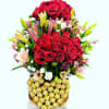 Red rose bouquet with pink lilies and Ferrero Rocher chocolates in a decorative container
