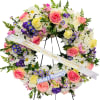 Heart-shaped floral wreath with pink roses, white daisies, and purple flowers
