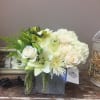 greens and whites on a silver vase