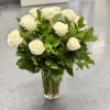 White roses arranged in a clear glass vase