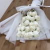 Bouquet of white roses wrapped in white mesh and paper