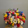 Colorful mixed flower basket with roses, daisies, and carnations