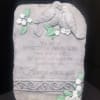 Stone memorial plaque with two doves and floral accents