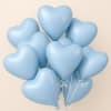 Cluster of light blue heart-shaped balloons with white ribbons