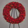 Red floral wreath on a black easel stand
