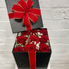 Black gift box with red roses and a large red bow