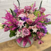 Pink and purple mixed bouquet in a gray vase with a satin ribbon
