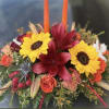 Colorful floral arrangement with sunflowers, red lilies, and orange roses