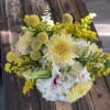 Bouquet of pale yellow and white flowers with pink lilies