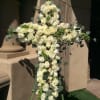 White rose cross arrangement with eucalyptus