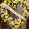 This heart shaped spray is designed with yellow and white roses, carnations