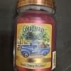 A jar candle labeled Candleberry Black Cherry Bourbon