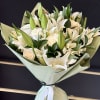 White lily and rose bouquet wrapped in pale green paper