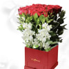 Red roses and white orchids in a red box