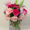 Pink mixed bouquet in a clear square glass vase