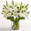 A serene cluster of white lilies and white roses creates a quietly