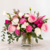 Pink and white flower arrangement in a clear glass vase