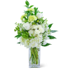 White and pale green floral arrangement in a clear glass vase