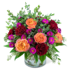 Orange and red roses with purple daisies in a glass vase