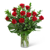 Red roses arranged in a clear glass vase