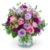 Bouquet of pink and lavender roses in a clear glass vase