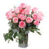 Pink roses arranged in a clear glass vase with greenery