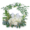 White roses and calla lilies in a circular floral wreath with angel figurines