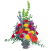 Tall mixed flower arrangement in a gray vase with bright red, orange, yellow, purple, and blue blooms