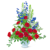 Tall red, white, and blue floral arrangement in a white vase