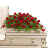 Red roses arranged on a white casket