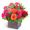 Pink and orange roses with red alstroemeria in a wooden box