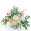 Bouquet of blush and white roses in a clear glass vase
