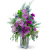 Purple and pink floral arrangement in a clear glass vase