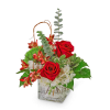 Red roses and white flowers in a square glass vase