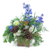 Blue flowers and white blooms in a rustic basket with pinecones