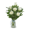 White roses in a glass vase with a blue ribbon