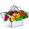 Bright mixed flower arrangement in a white handled gift box