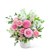 Pink roses and white flowers arranged in a white vase