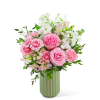 Pink roses and white flowers arranged in a green vase