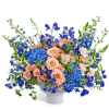 Peach roses and blue flowers in a white vase