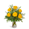 Yellow roses in a clear glass vase with mixed greenery