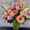 Pink and white mixed flower arrangement in a glass vase