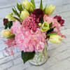 Pink and yellow mixed bouquet in a clear glass vase