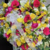 Bright pink and sunny yellow roses with white accents, yellow calla lilies