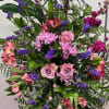 This standing spray features a mix of light pinks &amp;  purples.