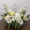 White floral arrangement with daisies and roses around a clear angel figurine